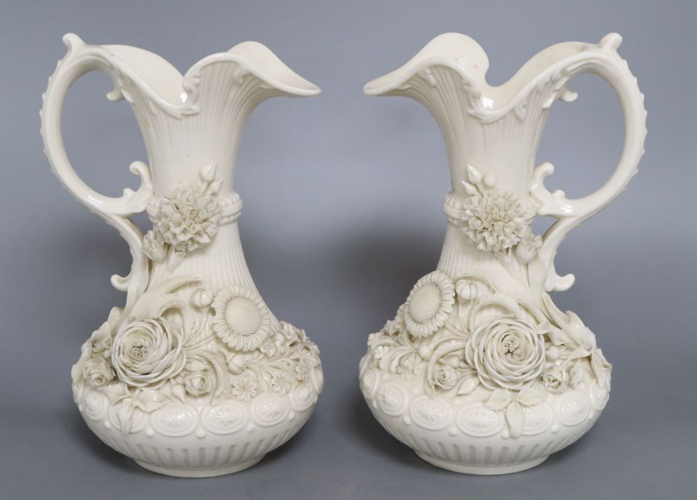 A pair of Belleek ewers, second period, height 23cm